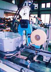 An articulated robot that rivets press worked work after pasting a sponge.